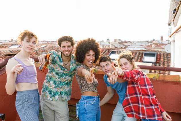 Young male and female friends on terrace during weekend party model released Symbolfoto property released IFRF01034