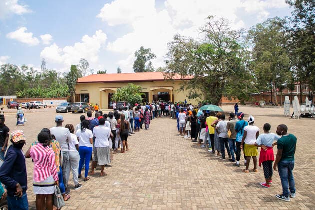 (210823) -- KIGALI, Aug. 23, 2021 -- People line up to receive the COVID-19 vaccine at a vaccination site in Kigali, Rwanda, on Aug. 23, 2021. Rwanda on Monday started the third phase of mass COVID-19 vaccinations targeting adults 18 years and above in Kigali, the Ministry of Health said. (Photo by Xinhua) RWANDA-KIGALI-COVID-19-VACCINATION CyrilxNdegeya 