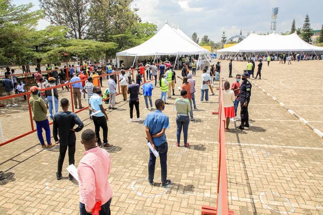 (210823) -- KIGALI, Aug. 23, 2021 -- People line up to receive the COVID-19 vaccine at a vaccination site in Kigali, Rwanda, on Aug. 23, 2021. Rwanda on Monday started the third phase of mass COVID-19 vaccinations targeting adults 18 years and above in Kigali, the Ministry of Health said. (Photo by Xinhua) RWANDA-KIGALI-COVID-19-VACCINATION CyrilxNdegeya 