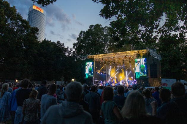 The concert railing of the Kunst Rasen in Bonn The Hip Hop Funk and Soul musician Jan Delay Jan Philipp Eißfeldt and the band Disko No 1 at the live performance on the Kunst Rasen Bonn Gronau Organizer ELHartz Promotion GmbH Bonn Gronau NRW Germany