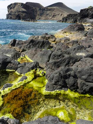 Creative Highlights World Vulcanic coast in the Nature Reserve Vulcao dos Capelinhos. Faial Island, an island in the Azores (Ilhas dos Acores) in the Atlantic ocean. The Azores are an autonomous region of Portugal. RoyaltyxFree 1028_RF_13_MZW16855