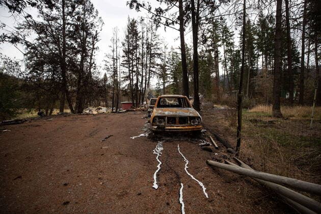 August 26, 2021, MONTE LAKE, BC, Canada: Metal from a car engine that melted is seen on the ground in front of the remains of a vehicle and a home that were destroyed by the White Rock Lake wildfire earlier this month, in Monte Lake, B.C., on Thursday, August 26, 2021. MONTE LAKE Canada  - ZUMAc35_ 20210826_zaf_c35_051 Copyright: xDarrylxDyckx