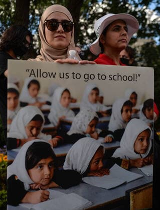 Rally Held In Edmonton In Support Of Afghan People Protester holds a placard with words Allow us to go to school! . Members of the local Afghan diaspora, activists and local supporters seen in front of the Alberta Legislature Building during the STOP KILLING AFGHANS! protest organised today by the Global Movement of Peace for Afghanistan. Saturday, August 28, 2021, in Edmonton, Alberta, Canada. Edmonton Canada widak-rallyhel210828_npp41  Copyright: xArturxWidakx