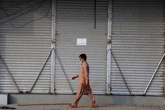 (210830) -- RAWALPINDI, Aug. 30, 2021 -- A man walks past a closed shop during COVID-19 restrictions in Rawalpindi of Pakistan s Punjab Province on Aug. 29, 2021. Pakistan on Sunday extended restrictions to 27 cities from the earlier 13 cities to control the serious fourth wave of COVID-19 in the country, the National Command and Operation Center (NCOC) said on Sunday. ) PAKISTAN-RAWALPINDI-COVID-19-RESTRICTION AhmadxKamal 