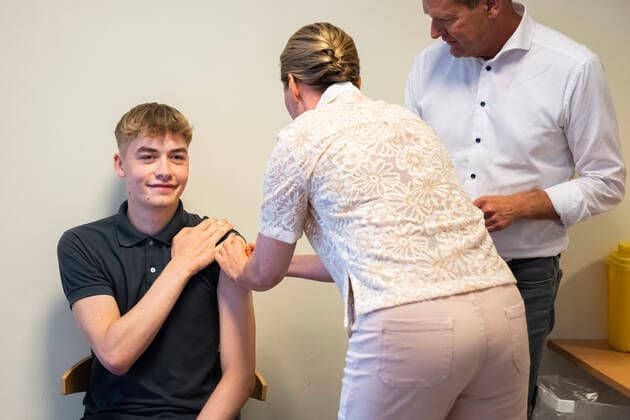 Prime Minister Mette Frederiksen and Director of the National Board of Health Soeren Brostroem give the student Magnus his first vaccination as a team Prime Minister Mette Frederiksen and Director of the National Board of Health Soeren Brostroem visit the emergency vaccination team at Broendby Gymnasium , Copenhagen Denmark  Copyright: MartinxSylvestx COP105 spdk20210831-165627-L