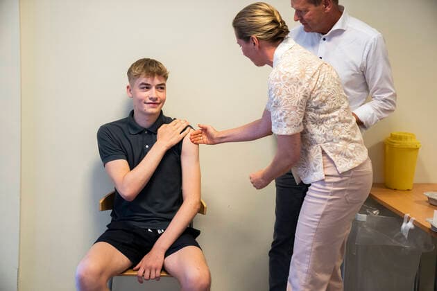 Prime Minister Mette Frederiksen and Director of the National Board of Health Soeren Brostroem give the student Magnus his first vaccination as a team Prime Minister Mette Frederiksen and Director of the National Board of Health Soeren Brostroem visit the emergency vaccination team at Broendby Gymnasium , Copenhagen Denmark  Copyright: MartinxSylvestx COP105 spdk20210831-165649-L