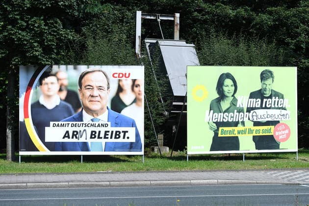 Election posters Bundestag election 2021 on 03 09 2021 in Oberhausen Two graffitied election posters CDU Christian Democratic Union of Germany Armin Laschet with the inscription Damit Deutschland arm bleibt Bündnis 90 Die Grünen Annalena Baerbock and Robert Habeck with the inscription Klima retten xRx
