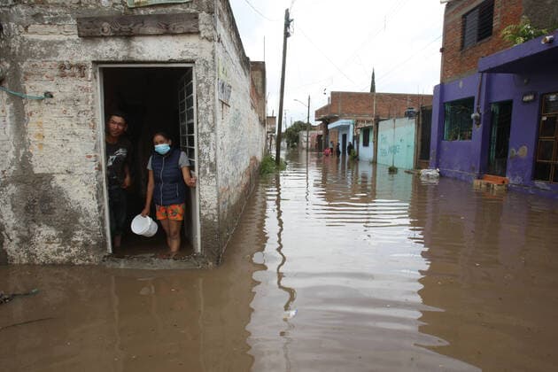 (210904) -- JALISCO, Sept. 4, 2021 -- People are seen inside a house flooded due to heavy rains, in the municipality of Tlaquepaque, State of Jalisco, Mexico, on Sept. 3, 2021. A strong storm during the early hours of Friday caused the El Chicharron and Las Pintas dams to overflow, flooding several areas of the municipality of Tlaquepaque. ) MEXICO-JALISCO-FLOOD ArturoxCampos 