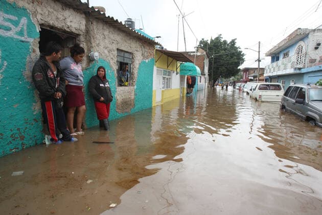 (210904) -- JALISCO, Sept. 4, 2021 -- People are seen on a street flooded due to heavy rains, in the municipality of Tlaquepaque, State of Jalisco, Mexico, on Sept. 3, 2021. A strong storm during the early hours of Friday caused the El Chicharron and Las Pintas dams to overflow, flooding several areas of the municipality of Tlaquepaque. ) MEXICO-JALISCO-FLOOD ArturoxCampos 