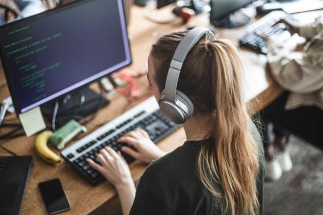 High angle view of female programmer working at startup company Sweden, Stockholm, model released, property released Copyright: xMaskotx , MA87950