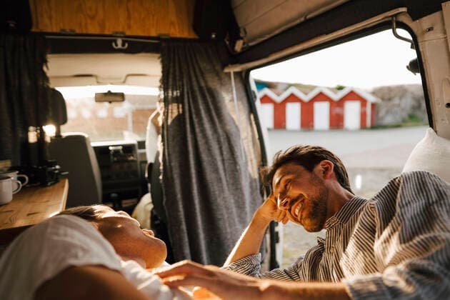 Smiling man talking with boyfriend while resting in camping van Sweden, Gothenburg, model released, property released Copyright: xMaskotx , MA88063