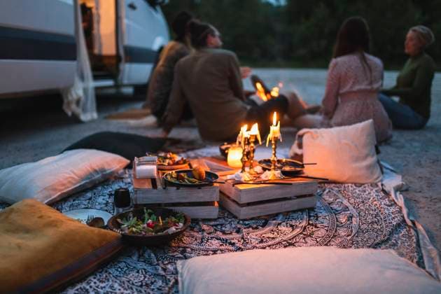 Female and male friends talking by camping van during vacation Sweden, Gothenburg, model released, property released Copyright: xMaskotx , MA88434