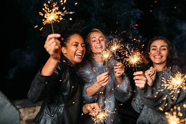 Young friends enjoying with sparklers at night Young friends enjoying with sparklers at night Copyright: xxArtemxVarnitsinx