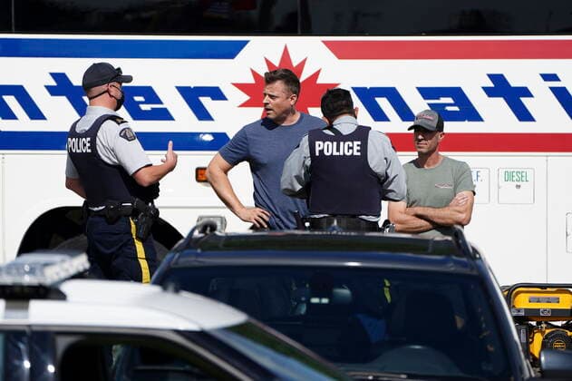 September 13, 2021, Burnaby, B.C, Canada: A lone protester talks to police after heckling Liberal leader Justin Trudeau as he takes part in an interview with Global reporter Neetu Garcha in Burnaby, B.C., on Monday, Sept. 13, 2021. The interview was set to take part outside but had to be moved inside due to the protester. Burnaby Canada  - ZUMAc35_ 20210913_zaf_c35_065 Copyright: xSeanxKilpatrickx