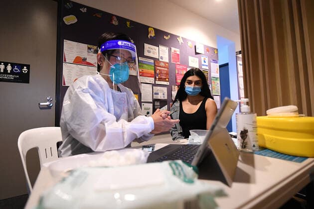 VICTORIA CORONAVIRUS COVID19, Healthcare worker Suman Rai (left) speaks with Marie Askaro before administering a Covid19 vaccination at a pop-up Covid19 vaccination clinic in Broadmeadows, Melbourne, Wednesday, September 15, 2021. Victoria s long-awaited roadmap out of lockdown will be released on Sunday, the premier has confirmed, as a man in his 20s became one of the state s latest COVID-19 victims. ( NO ARCHIVING, EDITORIAL USE ONLY, NO USE IN BOOKS WITHOUT CONSENT MELBOURNE VIC AUSTRALIA  Copyright: xJAMESxROSSx 20210915001576353818