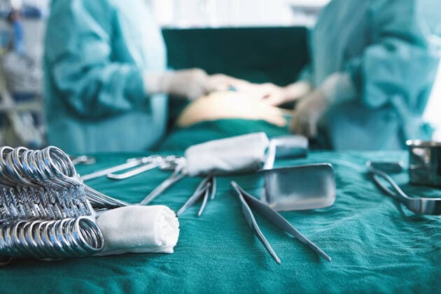 Close up of surgical instruments with surgeons performing surgery in maternity ward operating theatre, 04.12.2017, Copyright: xPhilippexRoyx, model released, , property released, wearing,using,working,cropped,side view,concentration,responsibility,cooperation,dedication,efficiency,hygiene,skill,teamwork,operating table,surgical equipment,surgical scissors,chinese ethnicity,caucasian ethnicity,multi-ethnic group,female,woman,mature woman,mid adult woman,only women,colleague,medical occupation,surgeon,indoors,hospital,operating theatre,surgical scrubs,protective clothing,modern,surgery,mid section,patient,maternity,only female,healthcare,medical science,December 2017 Release,private healthcare,maternity ward,womens health,Thinking,Concentra Ref:IS09B9G02