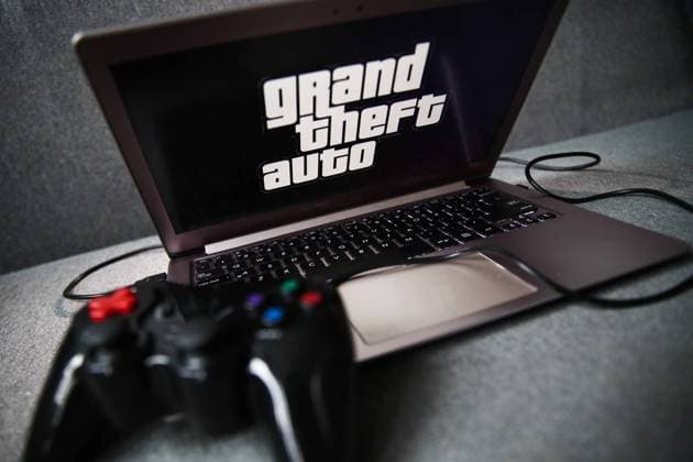 Video Games Brands Photo Illustrations Grand Theft Auto logo displayed on a laptop screen and a gamepad are seen in this illustration photo taken in Krakow, Poland on September 21, 2021. Krakow Poland porzycki-gamesbra210921_npJqU  Copyright: xJakubxPorzyckix