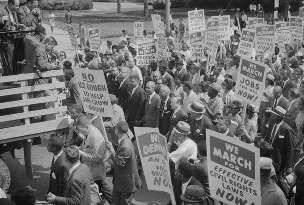 Photograph showing civil rights leaders, including Martin Luther King, Jr., surrounded by crowds carrying signs during the March on Washington. August 28, 1963. Photo by Warren K. Leffler. PhotoQuest Getty Images. 1063_05_Civil Rights March on Washington