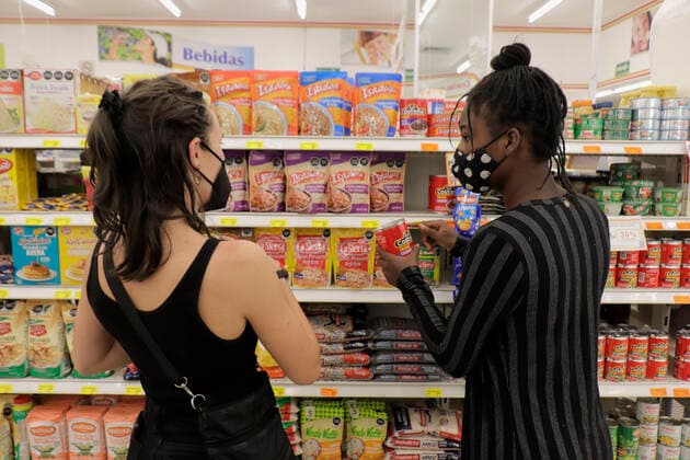 Inhabitants Of Mexico City Offer Solidarity Support To Haitian Migrants Isabela (left), an industrial design student at the CENTRO University - Diseno Cine Television, and a Haitian migrant (right) inside a self-service shop in Mexico City, pick out some products to be given to other migrants who recently arrived in the capital during the COVID-19 health emergency in the country. The migrants are trying to complete a procedure that will allow them to stay longer in Mexico due to the difficulties their compatriots are having in entering the United States. Mexico City Mexico vieyra-notitle210924_npjvV  Copyright: xGerardoxVieyrax