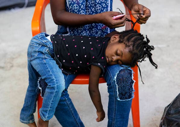 (210925) -- CIUDAD ACUNA (MEXICO), Sept. 25, 2021 -- A Haitian migrant braids her daughter s hair at a shelter in Ciudad Acuna, Mexico, on Sept. 25, 2021. U.S.-Mexico border arrests have reportedly stayed at the highest level in more than two decades, with more than 208,000 registered in August alone. (Photo by Xinhua) MEXICO-CIUDAD ACUNA-U.S.-BORDER-MIGRANTS NickxWagner 
