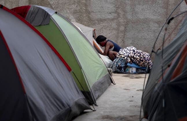 (210925) -- CIUDAD ACUNA (MEXICO), Sept. 25, 2021 -- A Haitian migrant cleans out her tent at a shelter in Ciudad Acuna, Mexico, on Sept. 25, 2021. U.S.-Mexico border arrests have reportedly stayed at the highest level in more than two decades, with more than 208,000 registered in August alone. (Photo by Xinhua) MEXICO-CIUDAD ACUNA-U.S.-BORDER-MIGRANTS NickxWagner 