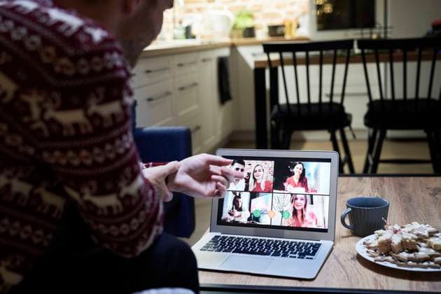 Young man talking with family through video conference during Christmas model released Symbolfoto property released ABIF01621