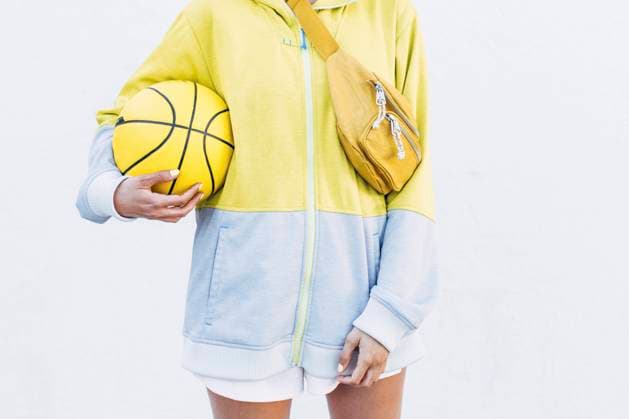 Young basketball player with with sports ball in front of white wall model released Symbolfoto EGHF00171