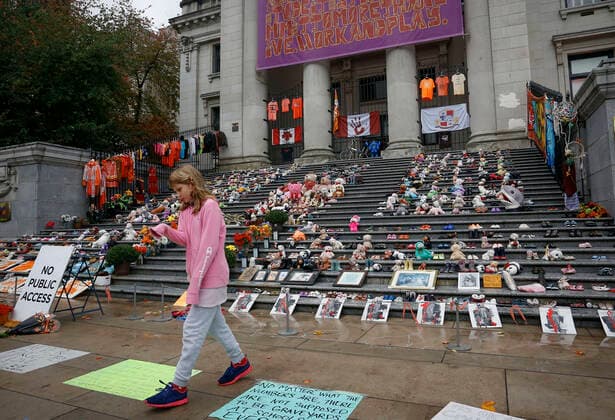 (210930) -- VANCOUVER, Sept. 30, 2021 -- A girl walks past toys and shoes at a commemoration event during the first National Day for Truth and Reconciliation in Vancouver, British Columbia, Canada, on Sept. 30, 2021. Canada marked its first National Day for Truth and Reconciliation on Thursday to honor lost children and survivors of the notorious indigenous residential school system in the country. (Photo by Xinhua) CANADA-VANCOUVER-NATIONAL DAY FOR TRUTH AND RECONCILIATION LiangxSen 