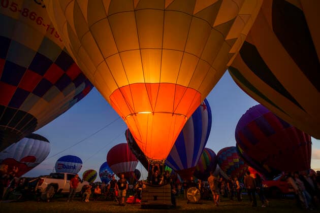October 2, 2021, albuquerque, New Mexico, USA: Fankie Martinez lights up the Raks Building Supply balloon for for the Twilight Twinkle Glow on the first night of the Albuquerque International Balloon Fiesta on Saturday, Oct. 2, 2021. During the Glow many of the balloons are inflated and lit up as the sun goes down. for the Albuquerque Journal albuquerque USA - ZUMAab1_ 20211002_zaf_ab1_038 Copyright: xNadavxSorokerx