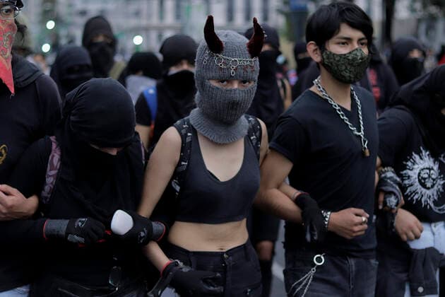 53rd Anniversary Of The Massacre Of Tlatelolco, Mexico In the centre, a member of the Black Bloc wears a hood with horns as she marches on Eje Central in Mexico City towards the Zocalo to mark the 53rd anniversary of the Tlatelolco Massacre that took place on 2 October 1968 in the square. Mexico City Mexico vieyra-notitle211002_npZML  Copyright: xGerardoxVieyrax