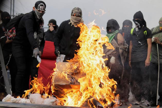 53rd Anniversary Of The Massacre Of Tlatelolco, Mexico Members of the Black Bloc burn a policeman s shield on Eje Central in Mexico City, while marching towards the Zocalo of the capital to mark the 53rd anniversary of the Tlatelolco Massacre that took place on 2 October 1968 in that square. Mexico City Mexico vieyra-notitle211002_np0my  Copyright: xGerardoxVieyrax