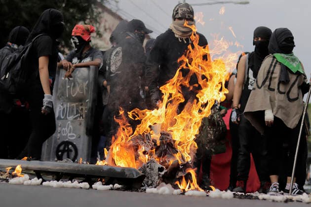 53rd Anniversary Of The Massacre Of Tlatelolco, Mexico Members of the Black Bloc burn a policeman s shield on Eje Central in Mexico City, while marching towards the Zocalo of the capital to mark the 53rd anniversary of the Tlatelolco Massacre that took place on 2 October 1968 in that square. Mexico City Mexico vieyra-notitle211002_npURK  Copyright: xGerardoxVieyrax