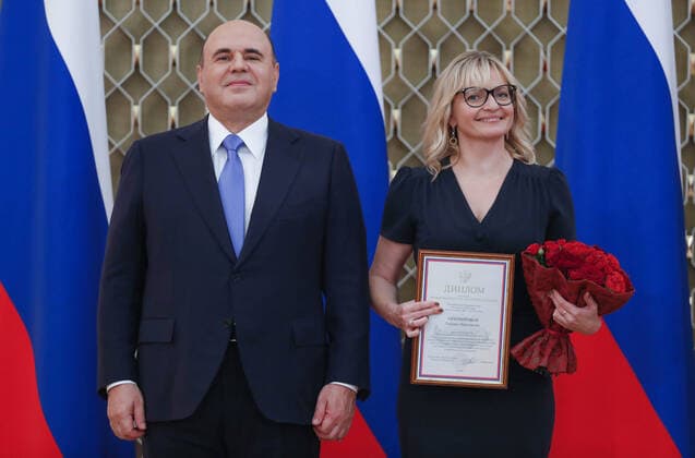 MOSCOW, RUSSIA - OCTOBER 5, 2021: Russia s Prime Minister Mikhail Mishustin (L) poses with Tatyana Tikhomirova, lab lead researcher at the Psychological Institute of the Russian Academy of Education, during a ceremony to award commendations and state prizes in the field of education and mark Teachers Day. Dmitry Astakhov POOL TASS  TS113221