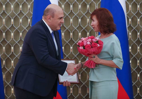 MOSCOW, RUSSIA - OCTOBER 5, 2021: Russia s Prime Minister Mikhail Mishustin (L) and South Ural State Humanitarian Pedagogical University professor Natalya Uvarina during a ceremony to award commendations and state prizes in the field of education and mark Teachers Day. Dmitry Astakhov POOL TASS  TS113228