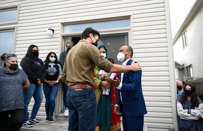 October 9, 2021, Ottawa, on, Canada: Prime Minister Justin Trudeau speaks with Obaidullah Rahimi, who worked at the Canadian Embassy in Afghanistan and was recently resettled with his family in Canada, in Ottawa, on Saturday, Oct. 9, 2021. Ottawa Canada  - ZUMAc35_ 20211009_zaf_c35_002 Copyright: xJustinxTangx