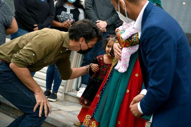 October 9, 2021, Ottawa, on, Canada: Prime Minister Justin Trudeau meets Ayat, 3, as he meets the family of Obaidullah Rahimi, right, who worked at the Canadian Embassy in Afghanistan and was recently resettled in Ottawa, on Saturday, Oct. 9, 2021. Ottawa Canada - ZUMAc35_ 20211009_zaf_c35_006 Copyright: xJustinxTangx