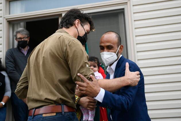 October 9, 2021, Ottawa, on, Canada: Prime Minister Justin Trudeau shares an embrace with Obaidullah Rahimi, who worked at the Canadian Embassy in Afghanistan and was recently resettled with his family in Canada, in Ottawa, on Saturday, Oct. 9, 2021. Ottawa Canada  - ZUMAc35_ 20211009_zaf_c35_011 Copyright: xJustinxTangx