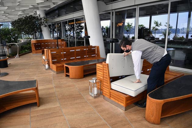 NSW CORONAVIRUS COVID19 REOPENING, Workers begin reopening preparation by setting up outdoor seating at Crown Sydney in Sydney, Sunday, October 10, 2021. From Monday, lockdown restrictions will lift for fully vaccinated people across NSW. ( NO ARCHIVING, EDITORIAL USE ONLY, NO USE IN BOOKS WITHOUT CONSENT SYDNEY NSW AUSTRALIA  Copyright: xJOELxCARRETTx 20211010001584634680