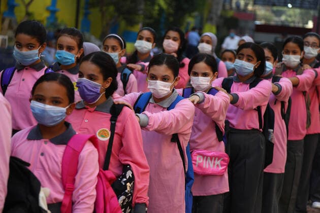(211010) -- CAIRO, Oct. 10, 2021 -- Students wearing face masks walk in lines at a middle school opened following months of closure due to COVID-19 in Cairo, Egypt, Oct. 10, 2021. Millions of school and university students began physically attending classes for the first time in 18 months starting Saturday in Egypt. Schools and universities have launched health awareness campaigns to urge students, teaching staff, and workers to adhere to all precautions against COVID-19, including maintaining physical distance and wearing face masks. ) EGYPT-CAIRO-STUDENTS-RETURN TO SCHOOL AhmedxGomaa 