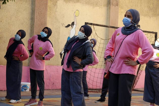 (211010) -- CAIRO, Oct. 10, 2021 -- Students wearing face masks take exercises at a middle school following months of closure due to COVID-19 in Cairo, Egypt, Oct. 10, 2021. Millions of school and university students began physically attending classes for the first time in 18 months starting Saturday in Egypt. Schools and universities have launched health awareness campaigns to urge students, teaching staff, and workers to adhere to all precautions against COVID-19, including maintaining physical distance and wearing face masks. ) EGYPT-CAIRO-STUDENTS-RETURN TO SCHOOL AhmedxGomaa 