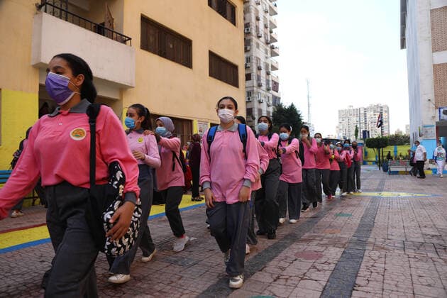 (211010) -- CAIRO, Oct. 10, 2021 -- Students wearing face masks walk in lines at a middle school opened following months of closure due to COVID-19 in Cairo, Egypt, Oct. 10, 2021. Millions of school and university students began physically attending classes for the first time in 18 months starting Saturday in Egypt. Schools and universities have launched health awareness campaigns to urge students, teaching staff, and workers to adhere to all precautions against COVID-19, including maintaining physical distance and wearing face masks. ) EGYPT-CAIRO-STUDENTS-RETURN TO SCHOOL AhmedxGomaa 