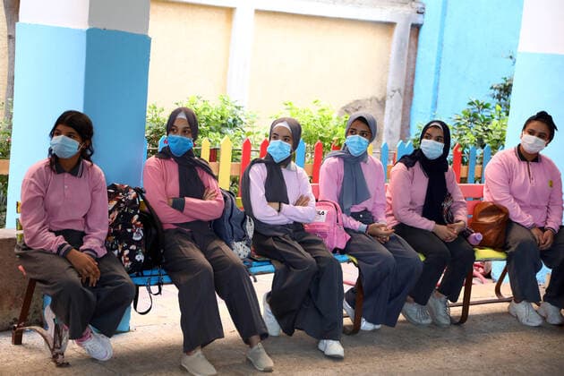 (211010) -- CAIRO, Oct. 10, 2021 -- Students wearing face masks attend the first class at a middle school following months of closure due to COVID-19 in Cairo, Egypt, Oct. 10, 2021. Millions of school and university students began physically attending classes for the first time in 18 months starting Saturday in Egypt. Schools and universities have launched health awareness campaigns to urge students, teaching staff, and workers to adhere to all precautions against COVID-19, including maintaining physical distance and wearing face masks. ) EGYPT-CAIRO-STUDENTS-RETURN TO SCHOOL AhmedxGomaa 