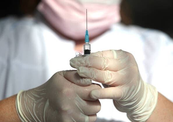 KAZAN, RUSSIA â€” OCTOBER 11, 2021: A nurse fills a syringe with a dose of vaccine against COVID-19 at a temporary vaccination site outside the Mega shopping centre. Since the start of the pandemic, Tatarstan has confirmed more than 27,000 cases of COVID-19. Since 1 October, the number of new confirmed cases has been increasing in Tatarstan by more than 60 daily. Tatarstan has announced additional restrictions which are coming into force starting from 11 October 2021 in connection with the rising daily number of new COVID-19 cases. People over 65 who havenâ€™t had COVID-19 or havenâ€™t received a vaccine against COVID-19 in the last six months are required to self-isolate. Theatres, cinemas, circuses and concert halls are allowed to fill not more  TS113BE7