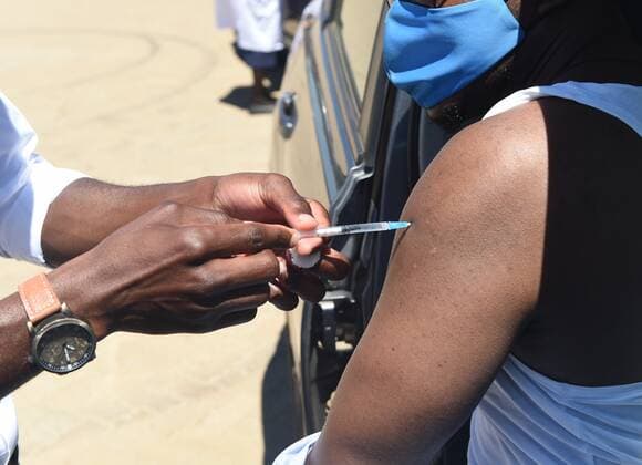 (211012) -- GABORONE, Oct. 12, 2021 -- A man receives the COVID-19 vaccine at a drive-through COVID-19 vaccination site in Gaborone, Botswana, on Oct. 12, 2021. A drive-through COVID-19 vaccination campaign started in Gaborone on Tuesday. (Photo by Xinhua) BOTSWANA-GABORONE-COVID-19-DRIVE-THROUGH VACCINATION TshekisoxTebalo 