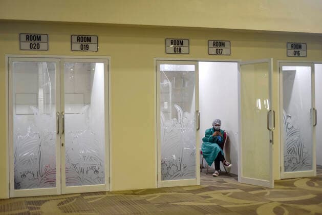 (211014) -- BALI, Oct. 14, 2021 -- A health worker is seen waiting at a swab test room at Ngurah Rai International Airport in Bali, Indonesia, Oct. 14, 2021. International visitors from 19 countries with a COVID-19 positivity rate of less than five percent have been allowed to come to Indonesia, Coordinating Minister for Maritime and Investment Affairs Luhut Binsar Pandjaitan said at a meeting in Jakarta on Wednesday. (Photo by Xinhua) INDONESIA-BALI-REOPEN-INTERNATIONAL VISITORS Bisinglasi 