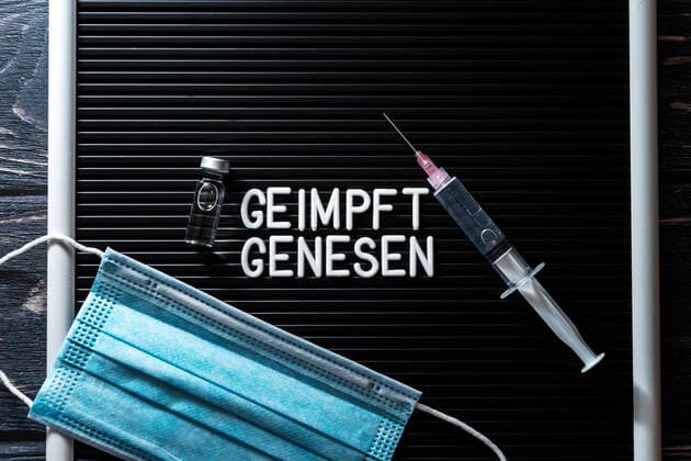 15 October 2021: Sign reading, Vaccinated and recovered, symbolic image for 2G rule, 2G rule in Germany excludes tested and unvaccinated individuals. Sign with syringe, test and mask