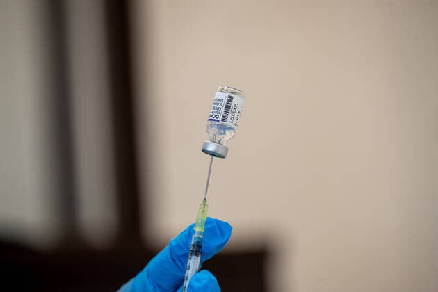 Mobile vaccination team in Pirna Symbolic image raising a vaccine syringe with the vaccine from Biontech Pfizer A mobile vaccination team vaccinates people in the Pirna Sonnenstein sports hall The offer is also intended to reach people who have not yet been vaccinated or who want to use this opportunity as a booster vaccination Pirna Saxony Germany Daniel Schäfer