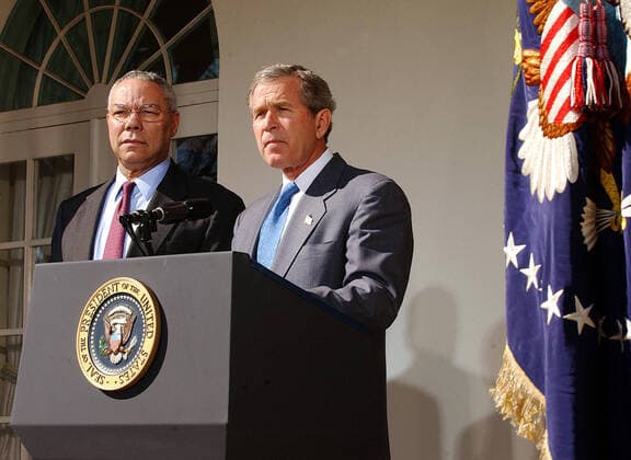 March 14, 2003, Washington, District of Columbia, USA: United States President George W. Bush speaks in the Rose Garden at the White House on March 14, 2003 in Washington as US Secretary of State Colin Powell looks on. Bush announced that he will unveil an additional plan for peace between Israelis and Palestinians, but that the new Palestinian PM would have to make considerable strides towards peace and the Israelis would have to stop the expansion of settlements Washington USA - ZUMAs152 20030314_zaa_s152_002 Copyright: xRonxSachsx