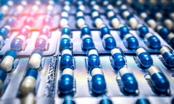 Blue and white capsules pill in blister pack arranged with beautiful pattern. Global healthcare concept. Antibiotics drug resistance. Antimicrobial capsule pills. Pharmaceutical industry. Copyright: xx 26945072