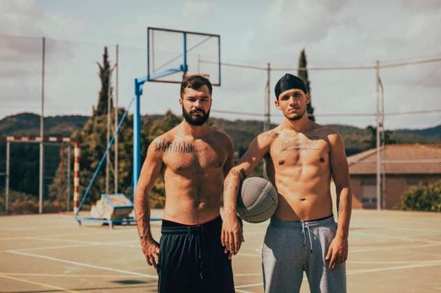 Shirtless male friends with basketball standing at sports court model released Symbolfoto property released ACPF01336